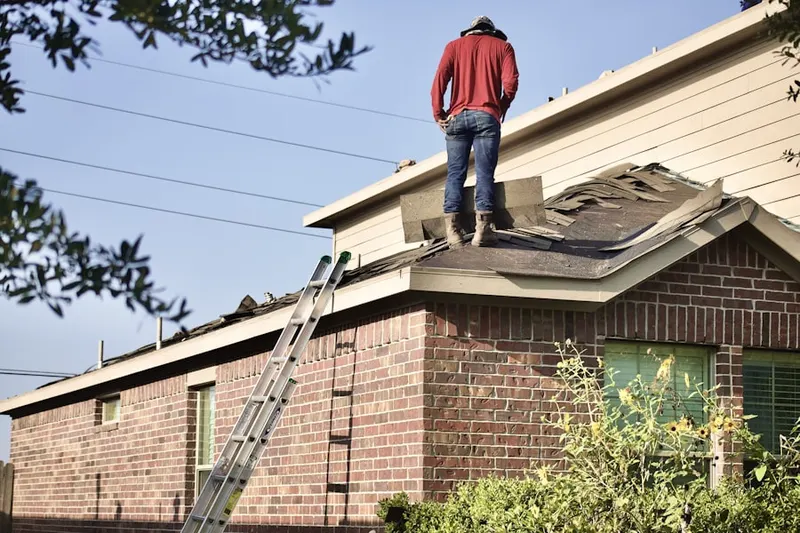 Professional roofer working on a residential roof in Memorial